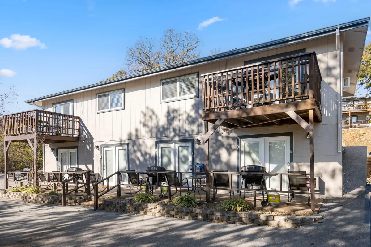 This image showcases several balconies outfitted with BBQ grills and outdoor seating, set against a backdrop of warm evening light. The scene captures the spirit of relaxation and social gatherings, with multiple spaces for guests to enjoy outdoor meals, sunset views, and morning coffee.