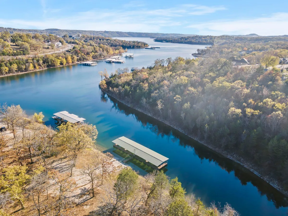 A scenic view of a winding river with boats and a wooded shoreline, suggesting opportunities for boating, fishing, hiking, and tranquil outdoor adventures. The image evokes a sense of tranquility and exploration beyond the property itself.